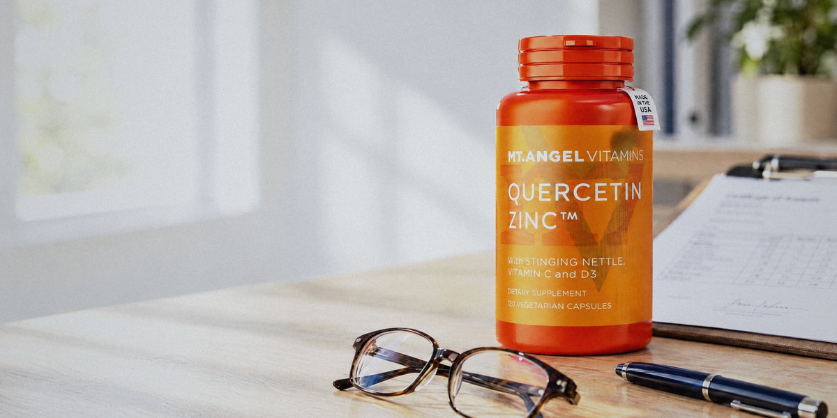 Mt. Angel Vitamins Quercetin Zinc bottle beside a certificate of analysis on a clipboard